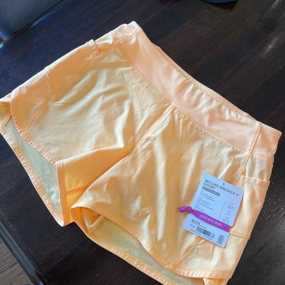 Athleta Girl shorts (juniors) tangerine colored, 3 inch athletic shorts.